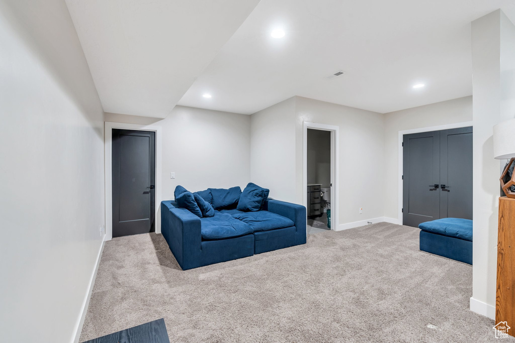 Carpeted living room with baseboards and recessed lighting