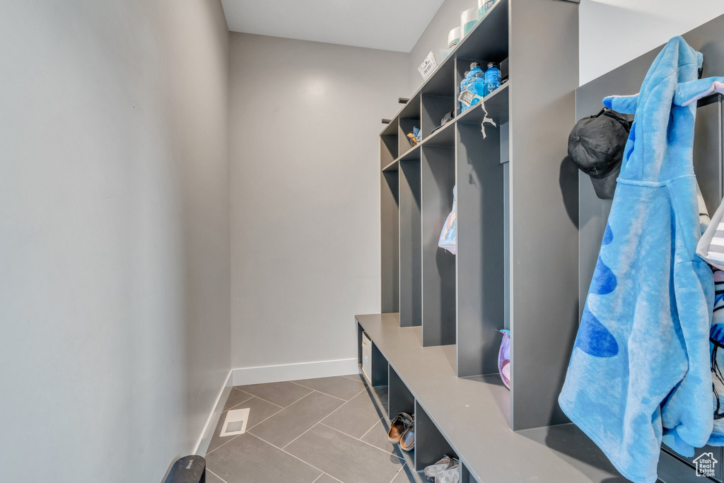 Mudroom featuring tile patterned flooring and baseboards
