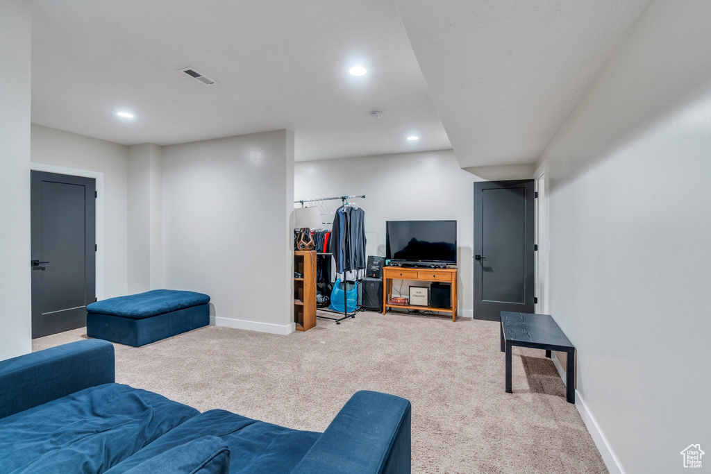 Living area featuring light carpet, recessed lighting, and baseboards