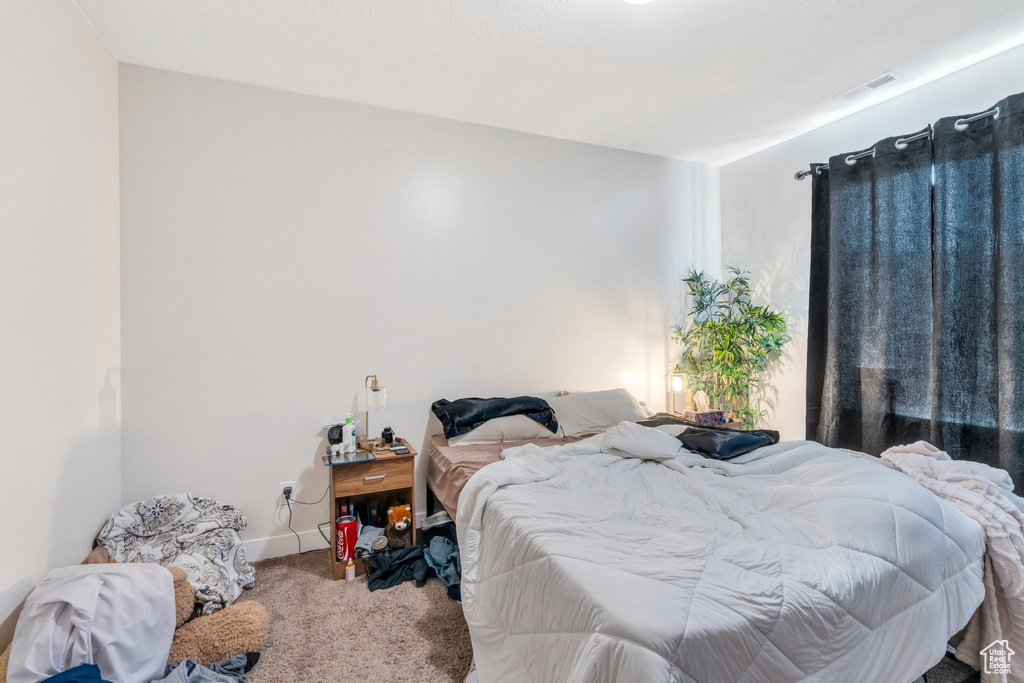 Bedroom with carpet and baseboards
