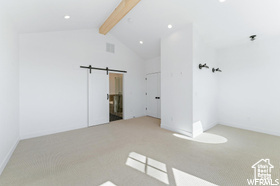 Carpeted spare room with recessed lighting and a barn door