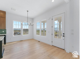 Unfurnished dining area with light wood-style flooring, a chandelier, baseboards, and recessed lighting