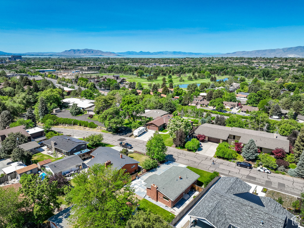 Aerial perspective of suburban area with a water and mountain view