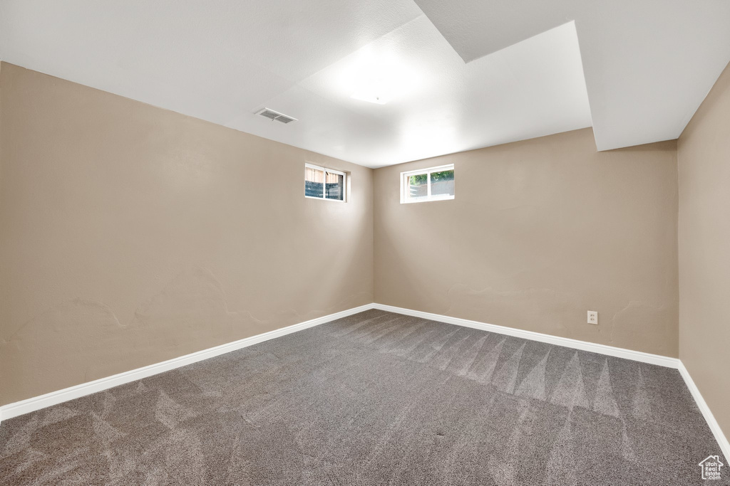 Empty room with carpet floors and baseboards
