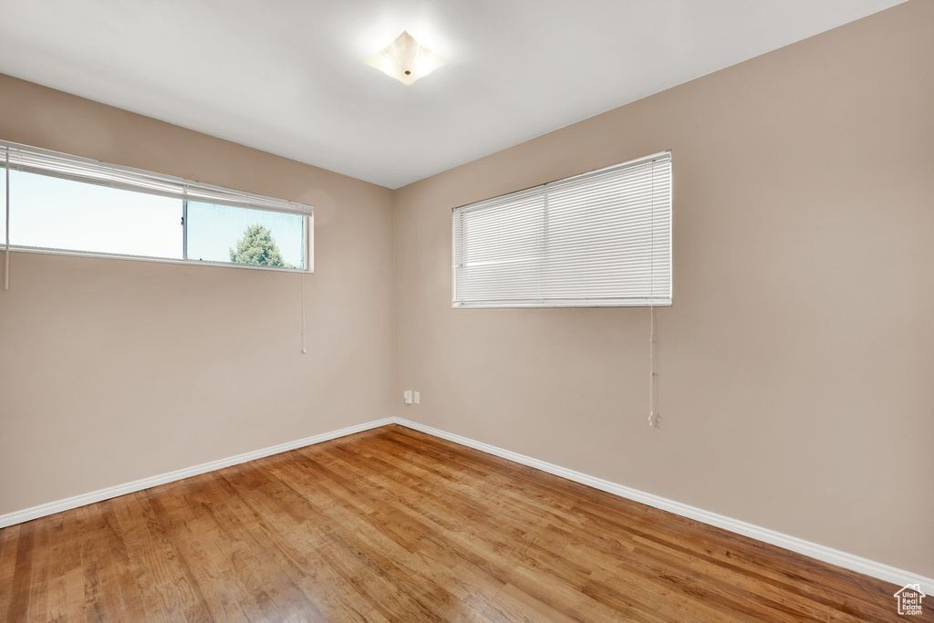 Unfurnished room featuring baseboards and light wood finished floors