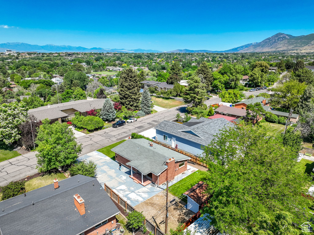 Aerial view of residential area featuring a mountainous background