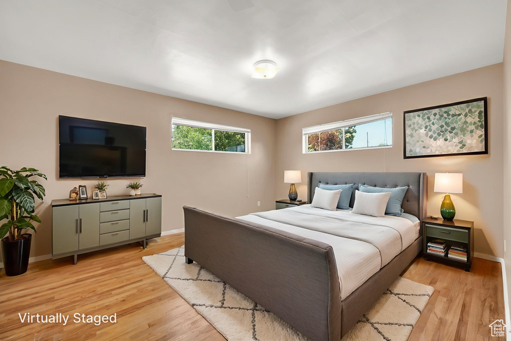 Bedroom featuring light wood-style floors and baseboards