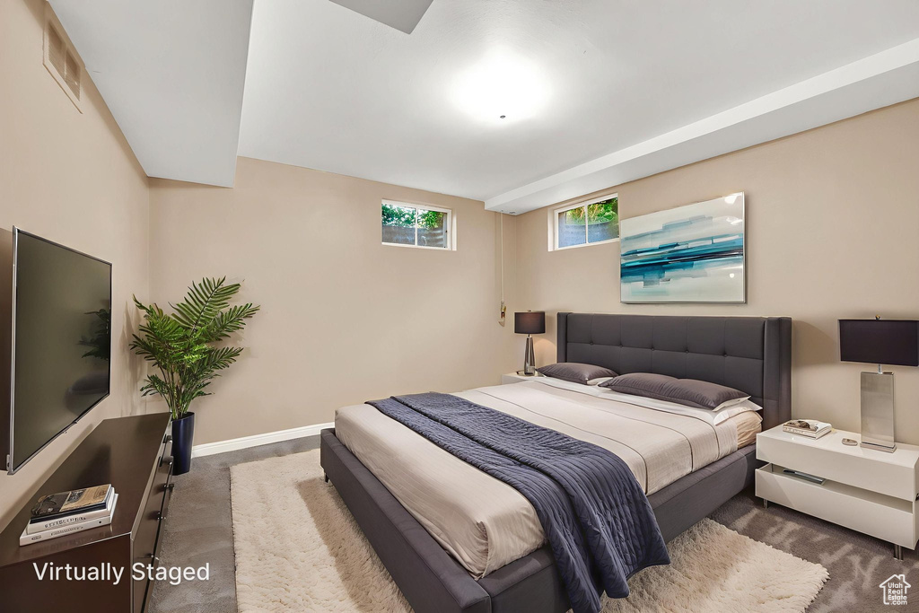 Carpeted bedroom featuring baseboards