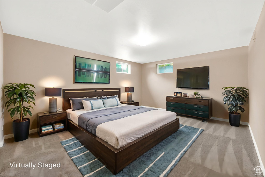 Bedroom with light carpet and baseboards