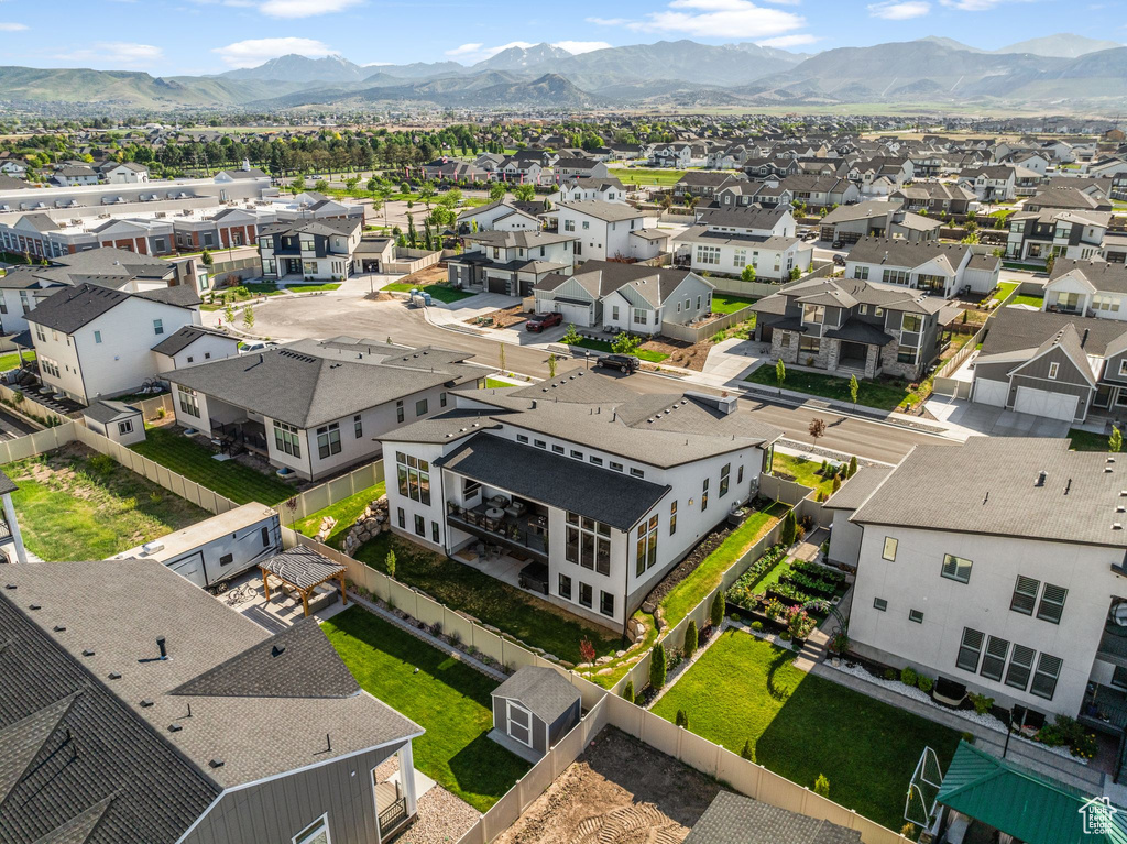 Aerial view of residential area featuring a mountainous background