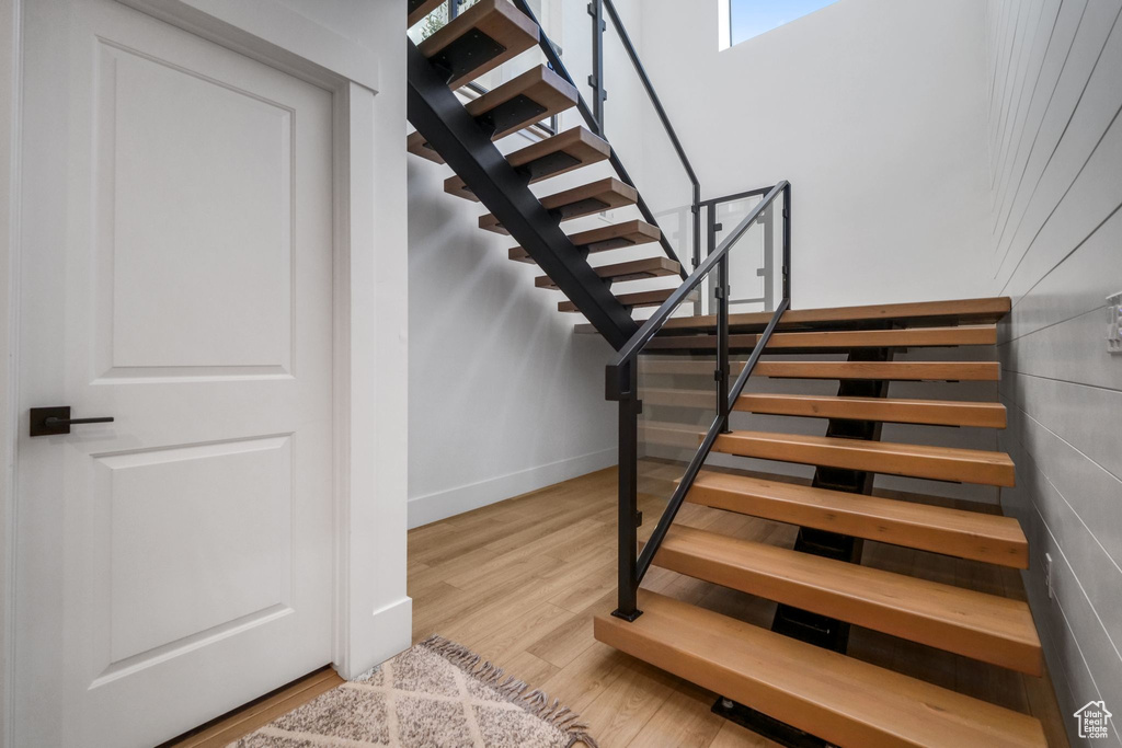 Staircase featuring wood finished floors and baseboards