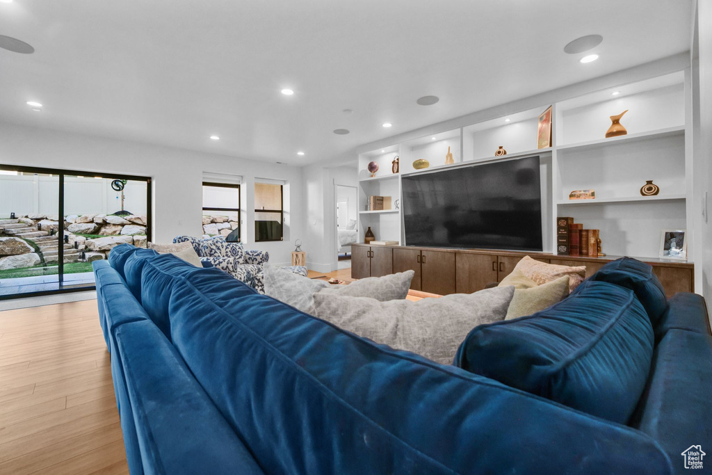 Living area featuring light wood-style floors and recessed lighting