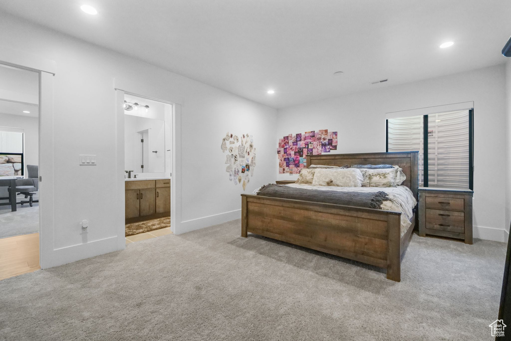 Carpeted bedroom with recessed lighting, baseboards, and connected bathroom