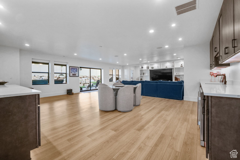 Living area featuring light wood finished floors, recessed lighting, and baseboards