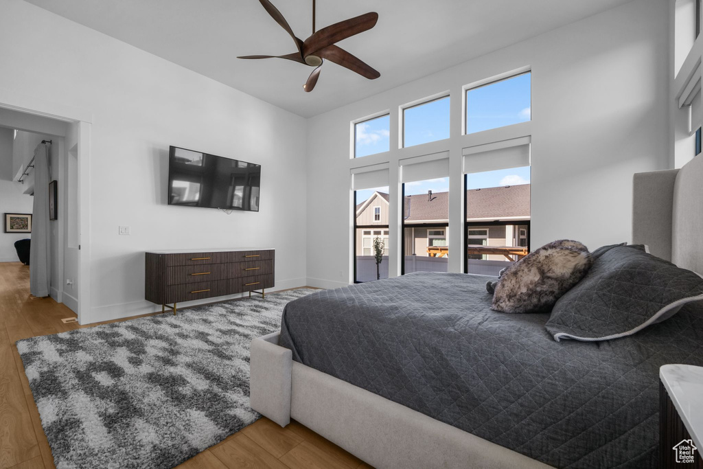 Bedroom with wood finished floors, baseboards, and ceiling fan