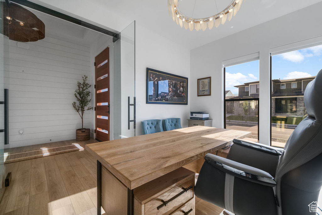 Office space featuring wood finished floors and wood walls