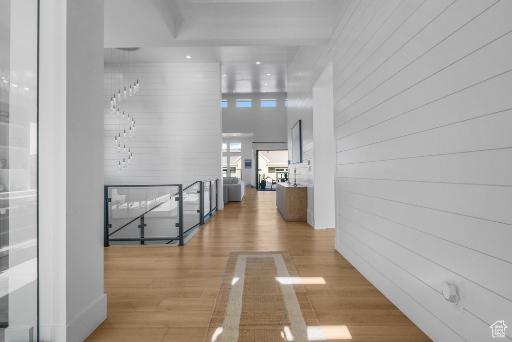 Corridor with wood finished floors and wooden walls