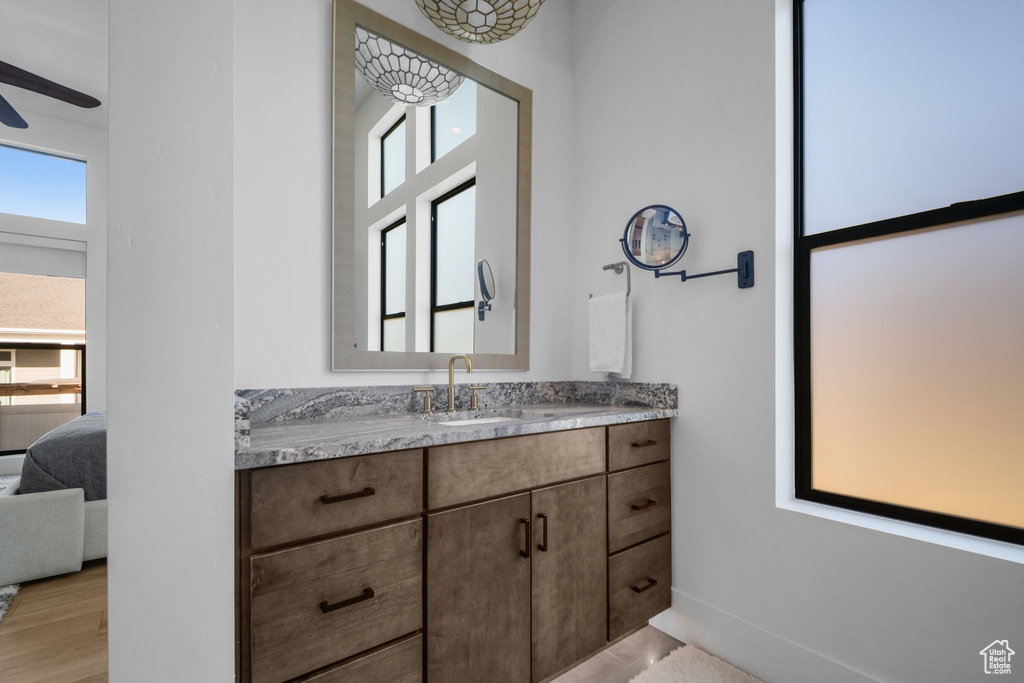 Bathroom featuring plenty of natural light, vanity, and connected bathroom