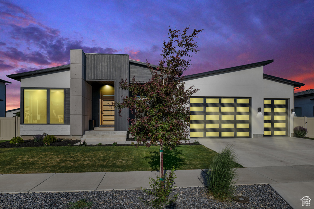 Modern home featuring an attached garage and driveway