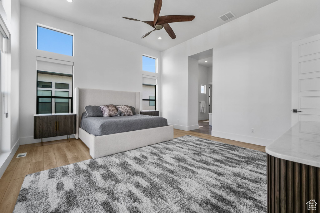 Bedroom featuring wood finished floors, recessed lighting, baseboards, ceiling fan, and connected bathroom