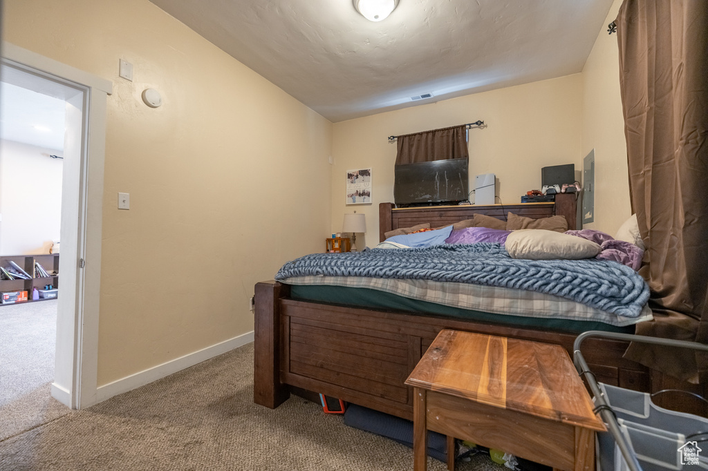 Bedroom featuring carpet flooring and baseboards