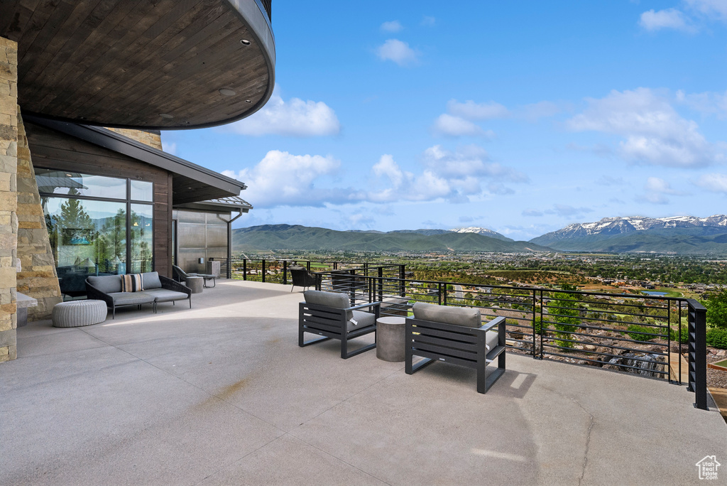 View of patio / terrace with a mountain view and a balcony