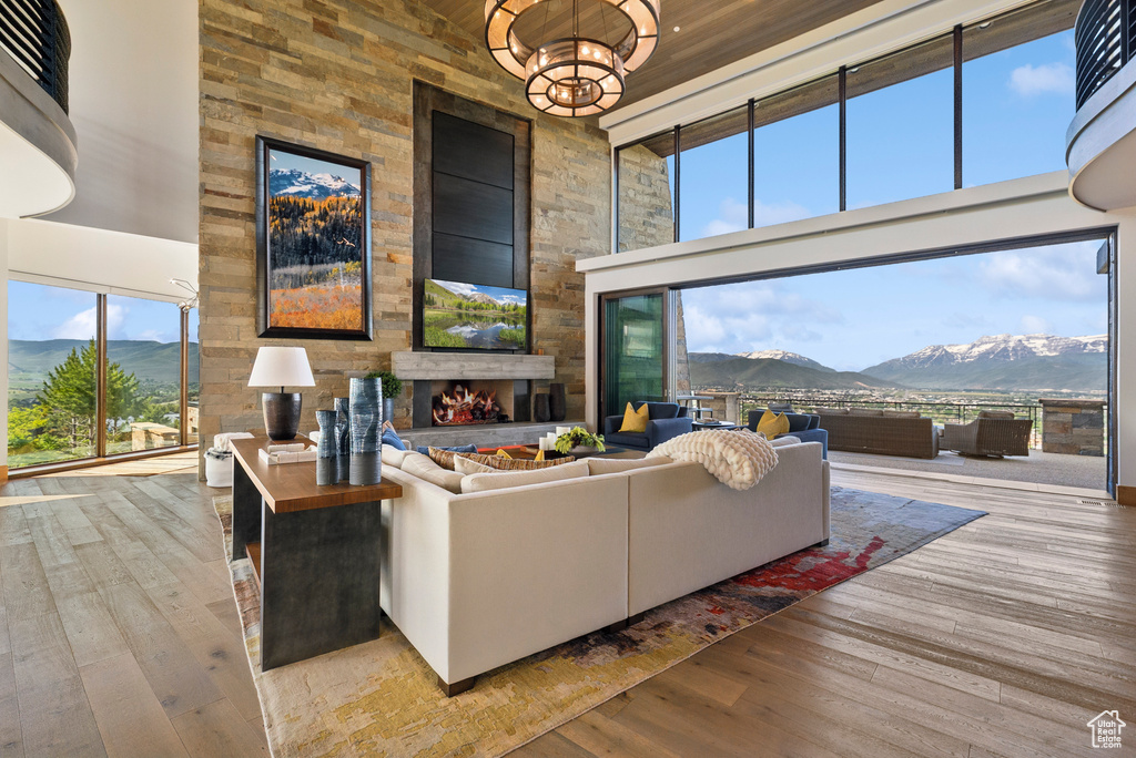 Living area with a high ceiling, hardwood / wood-style flooring, and a fireplace