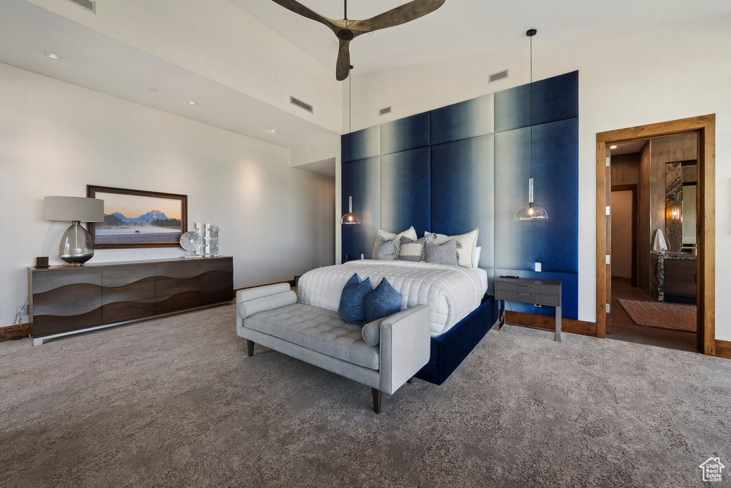 Carpeted bedroom with ceiling fan and baseboards