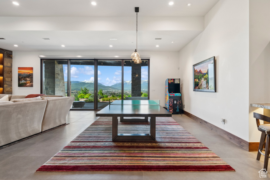 Dining room featuring a mountain view, recessed lighting, finished concrete floors, and baseboards