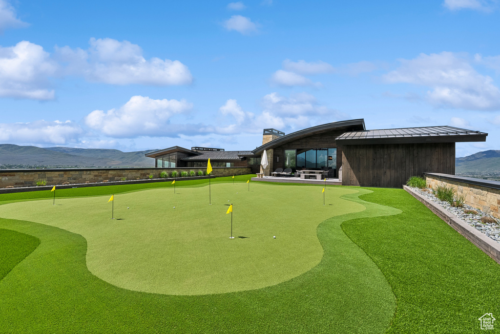 Surrounding community with an area to practice putting and a mountain view