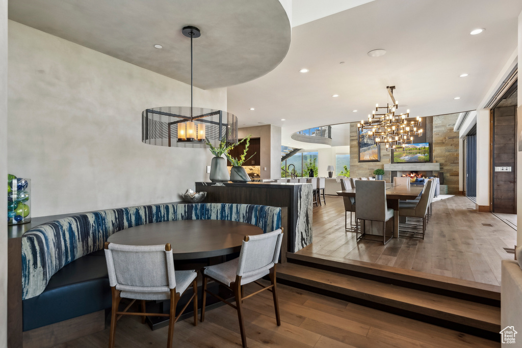 Dining area with a chandelier, hardwood / wood-style flooring, and recessed lighting