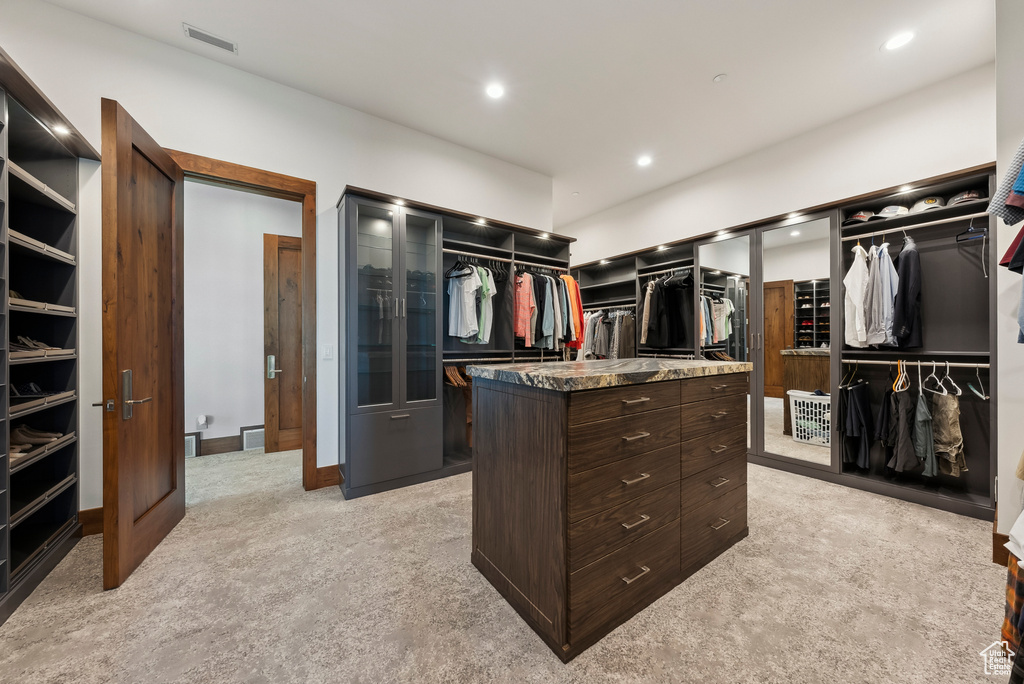 Spacious closet with light colored carpet