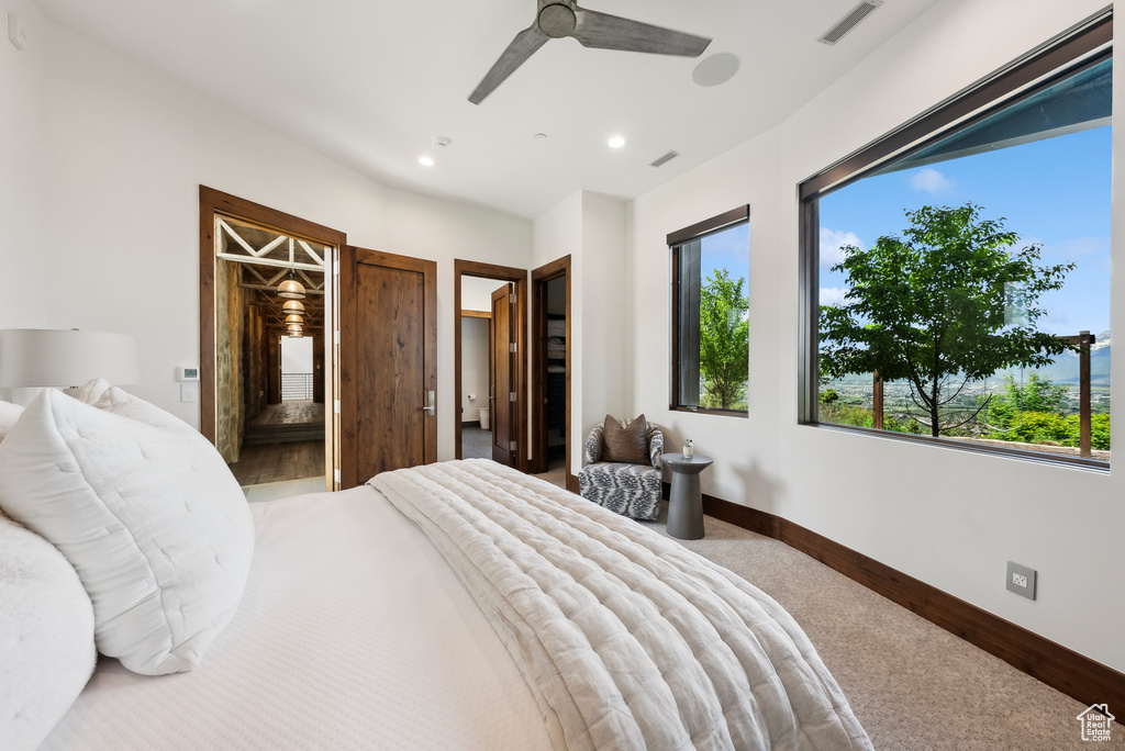 Carpeted bedroom with recessed lighting, baseboards, a ceiling fan, and ensuite bathroom