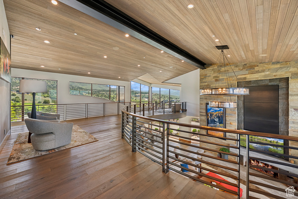 Corridor with wood-type flooring, wood ceiling, a chandelier, and recessed lighting