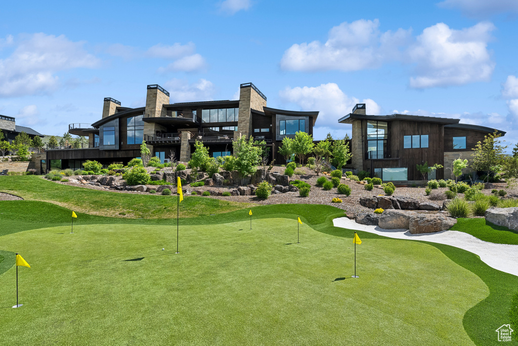 View of home\'s community featuring an area to practice putting and view of golf course