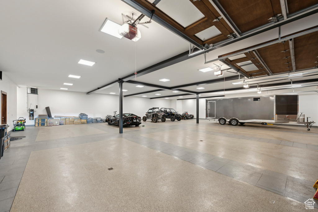 Garage featuring a garage door opener and recessed lighting