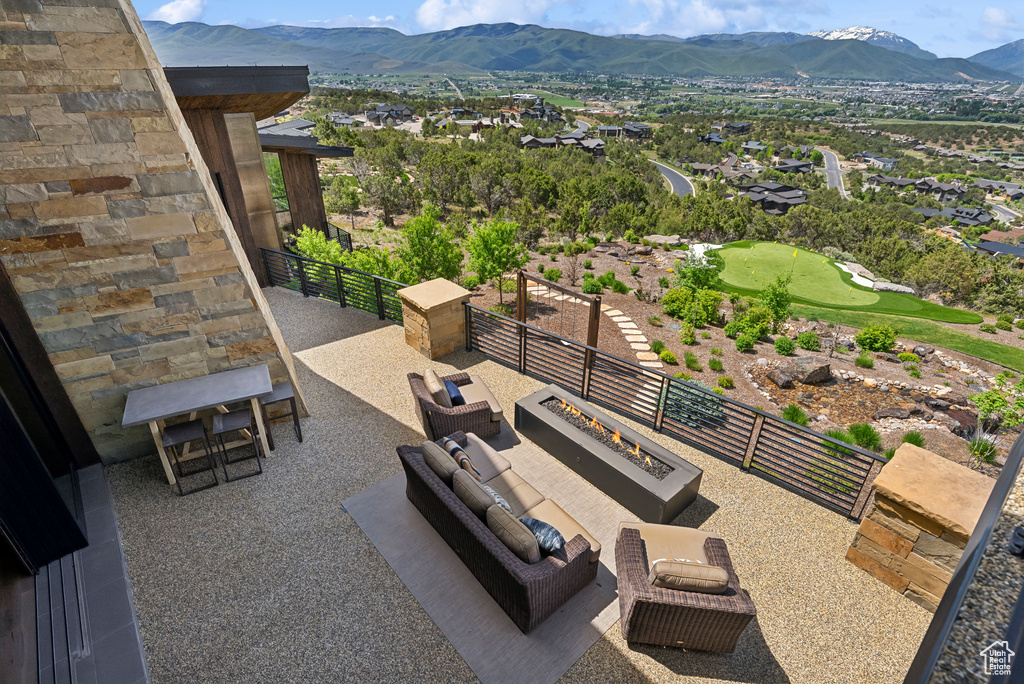 View of patio / terrace featuring a mountain view and an outdoor living space with a fire pit