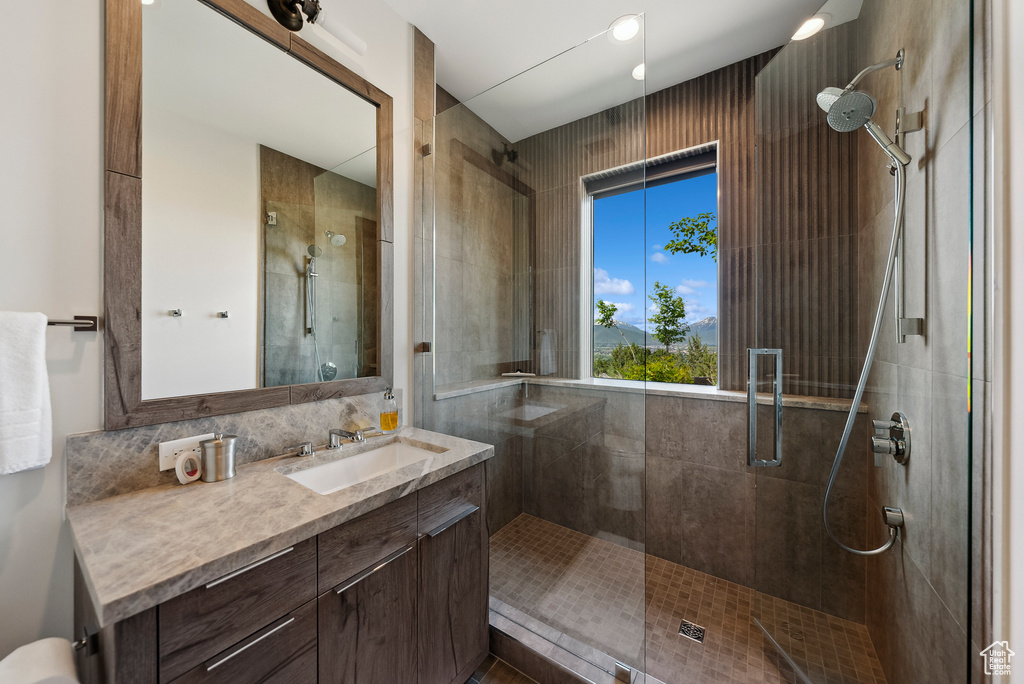 Bathroom featuring a stall shower and vanity