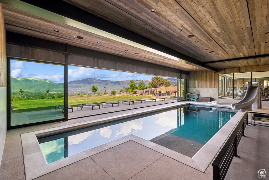 Swimming pool with a water slide and a mountain view