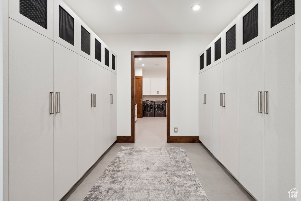 Hall featuring washing machine and dryer, recessed lighting, and baseboards