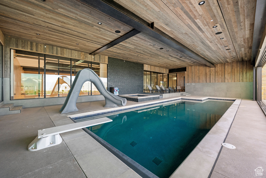 Indoor pool with a water slide and a diving board