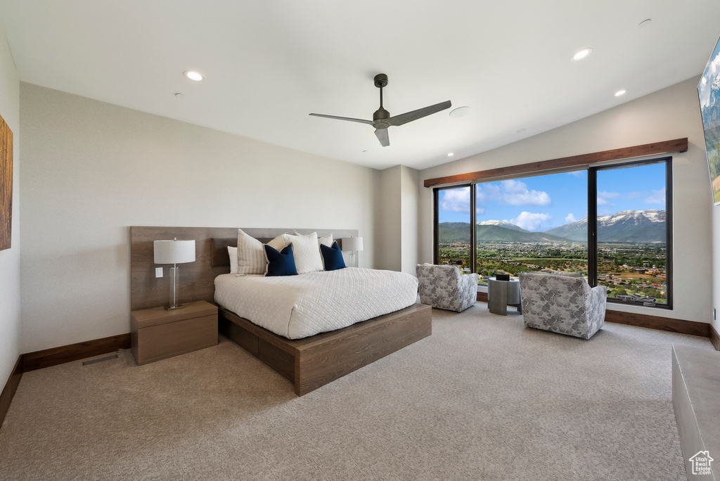 Carpeted bedroom featuring a mountain view, baseboards, a ceiling fan, and recessed lighting