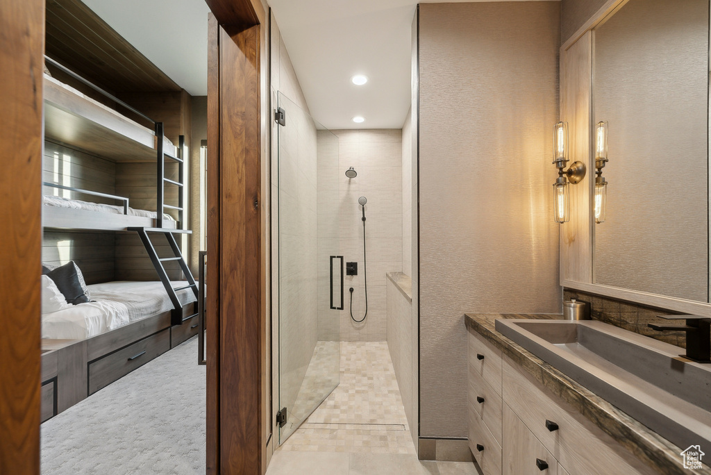 Full bathroom featuring a shower stall, vanity, ensuite bathroom, a textured wall, and recessed lighting