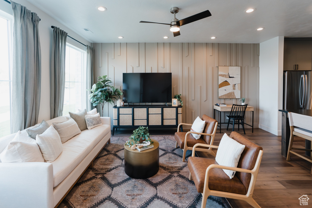 Living room featuring wood finished floors, recessed lighting, ceiling fan, and baseboards