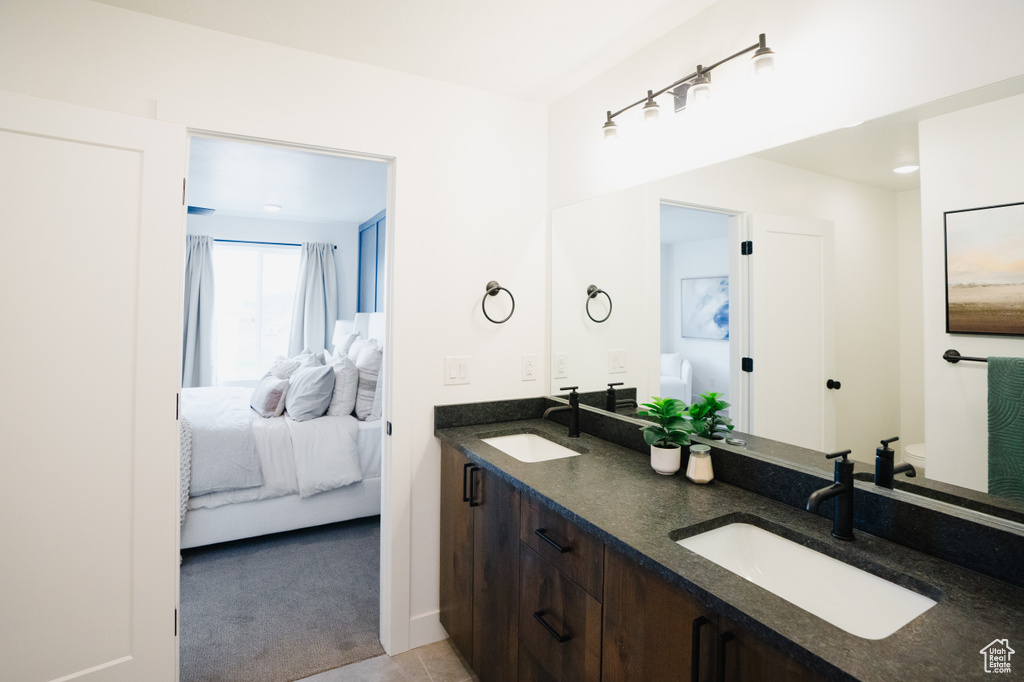 Bathroom featuring ensuite bathroom and double vanity
