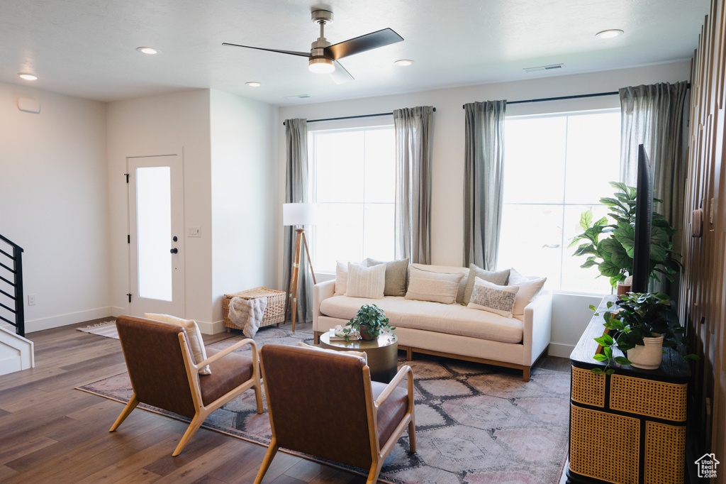 Living room featuring wood finished floors, ceiling fan, baseboards, and recessed lighting