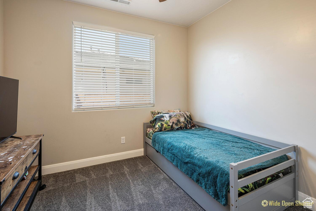 Bedroom featuring baseboards and carpet flooring