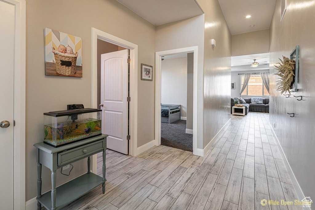 Hallway featuring light wood-style floors and baseboards