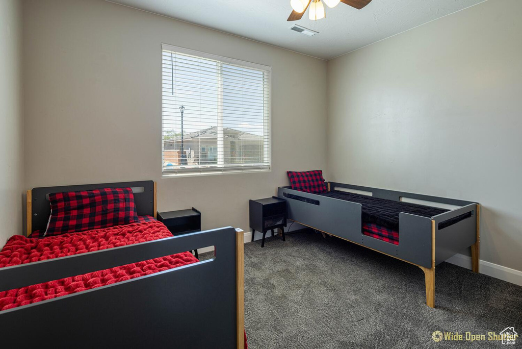 Bedroom featuring carpet flooring, baseboards, and a ceiling fan