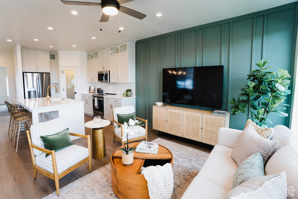 Living room featuring ceiling fan, light wood finished floors, and recessed lighting